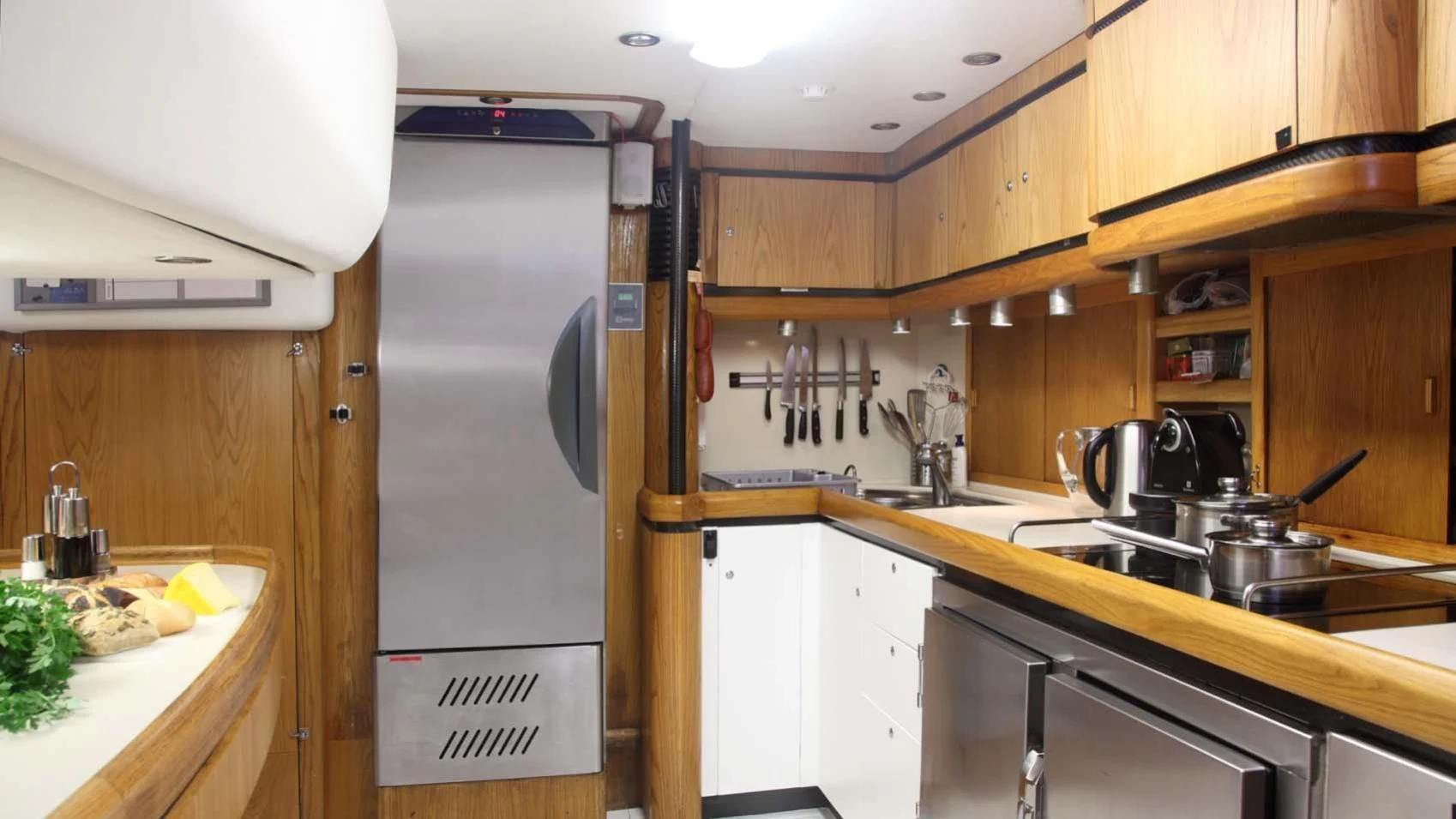 a kitchen with a fridge and a sink aboard MARIA ALBA II Yacht for Sale