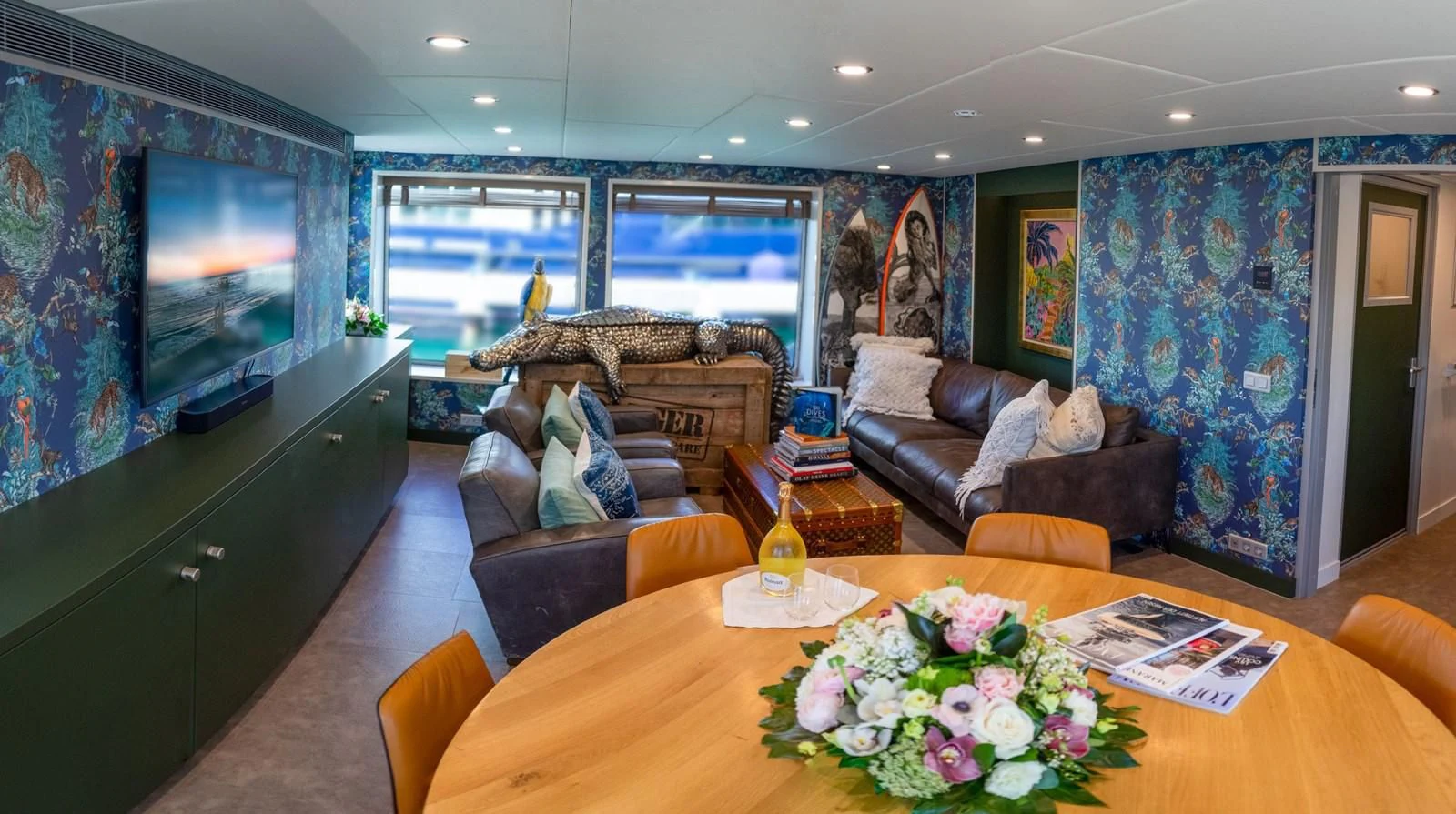 a living room with a large screen aboard BAD COMPANY SUPPORT Yacht for Charter