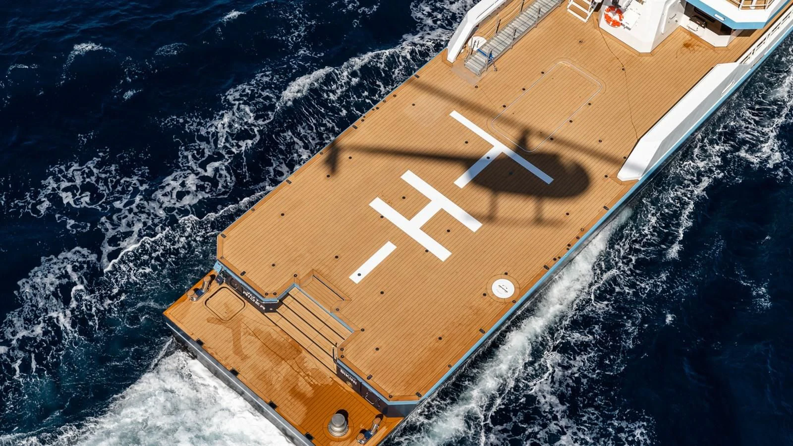 a large building with a road and trees around it aboard BAD COMPANY SUPPORT Yacht for Charter