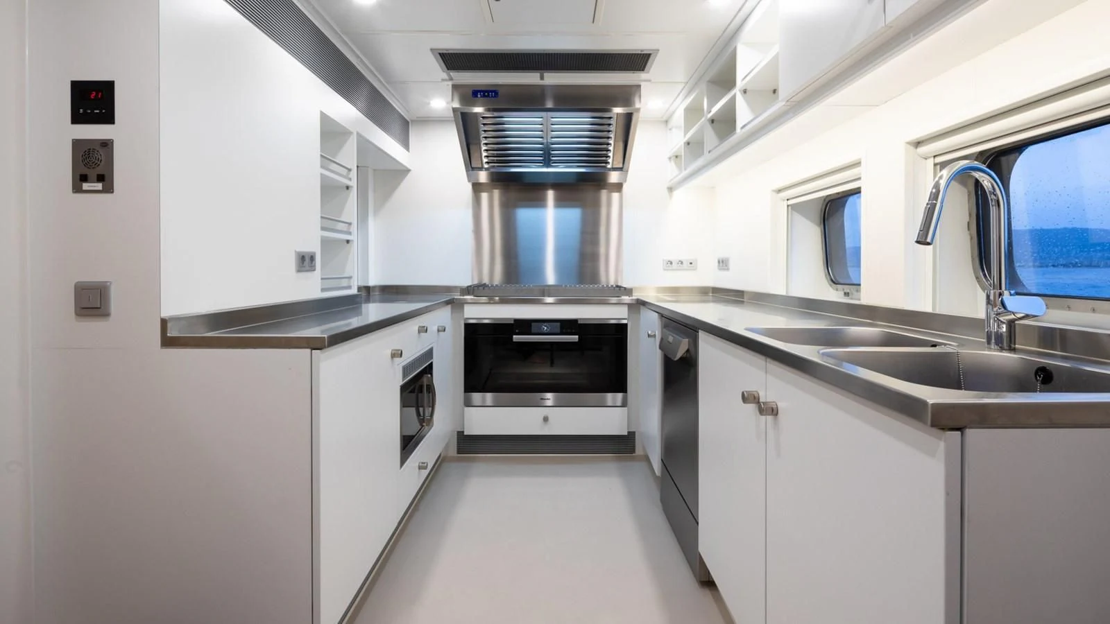 a kitchen with white cabinets aboard BAD COMPANY SUPPORT Yacht for Charter