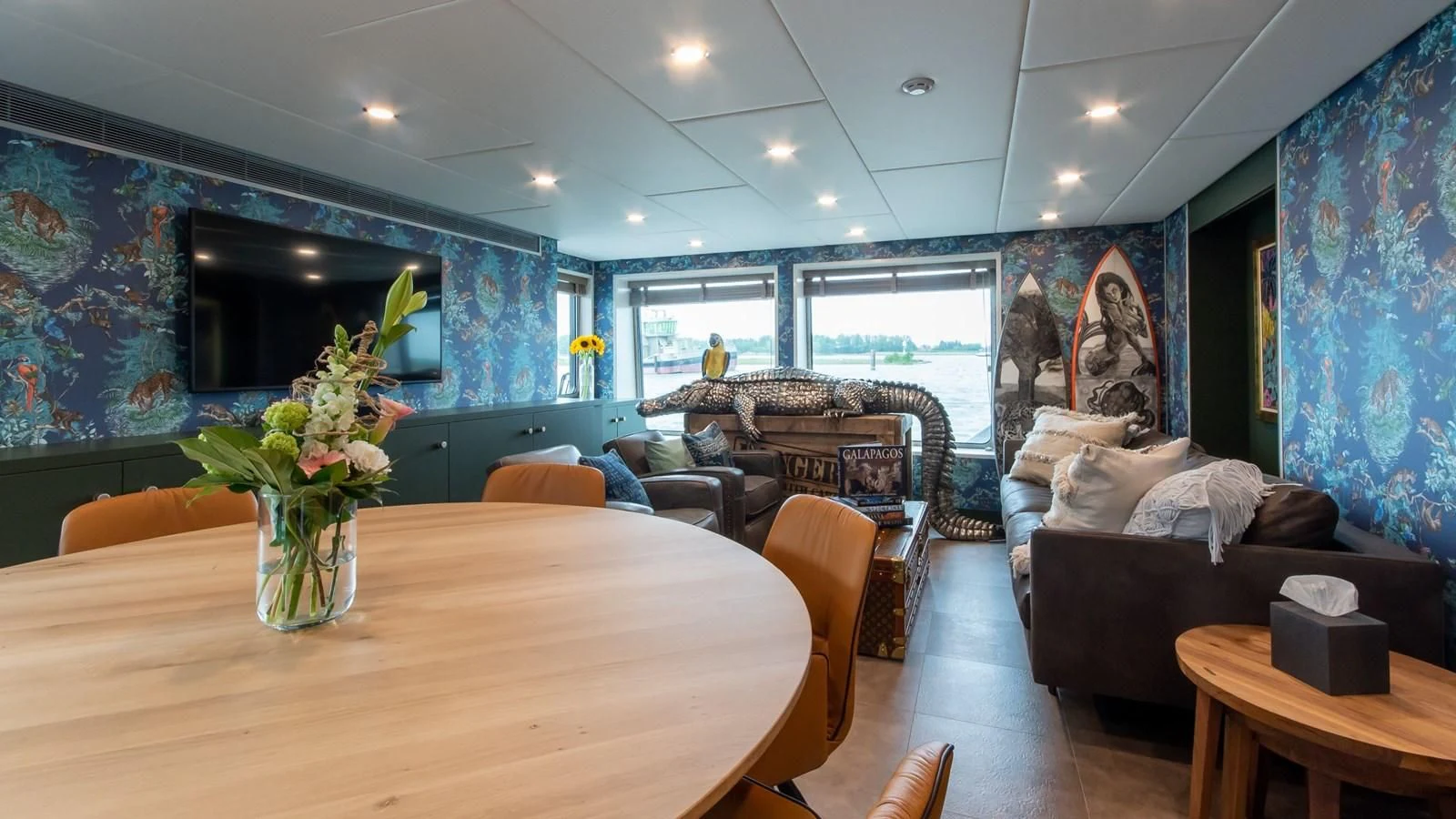 a living room with a large table and couches aboard BAD COMPANY SUPPORT Yacht for Charter