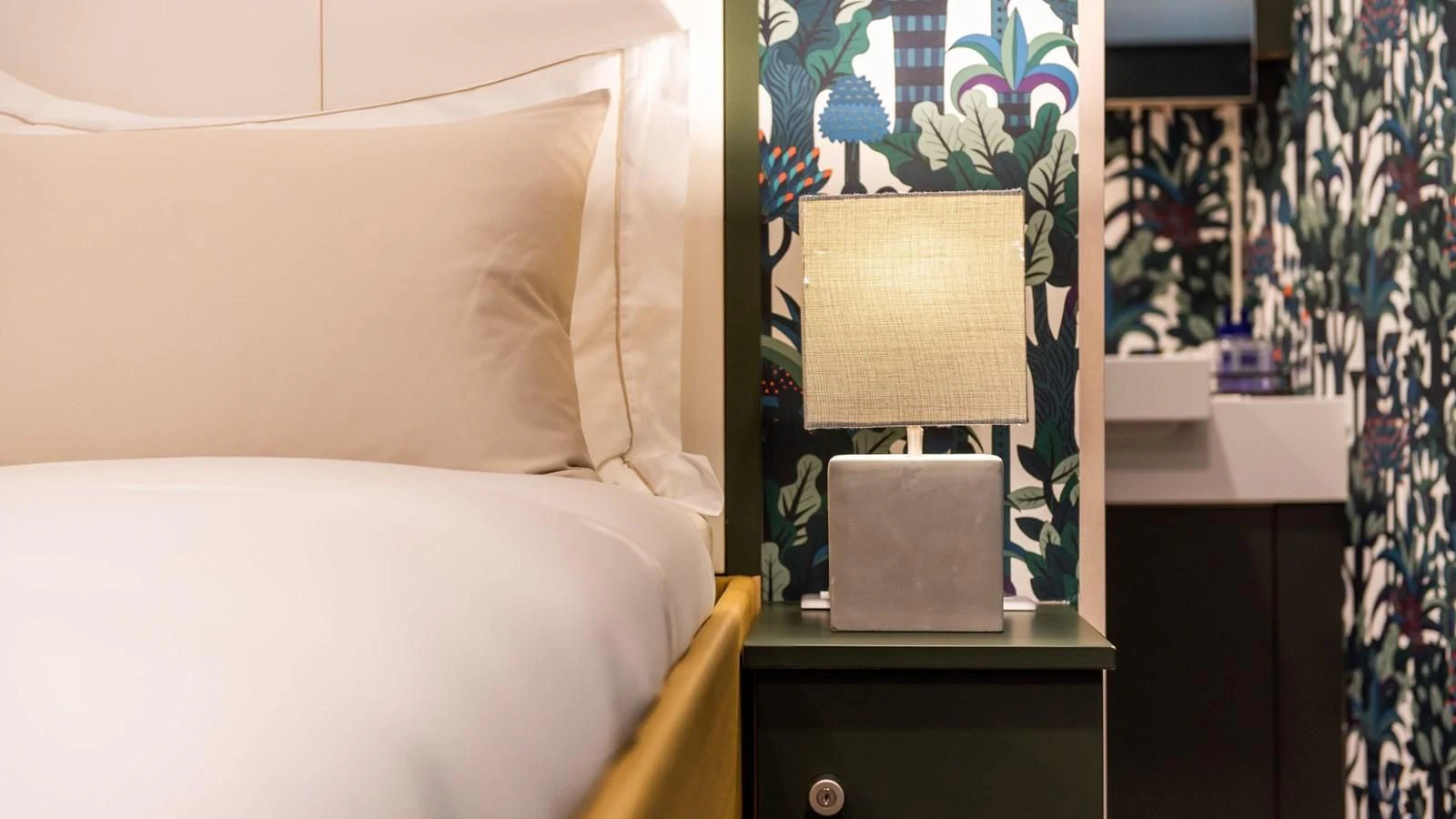 a bedroom with a lamp and a bed aboard BAD COMPANY SUPPORT Yacht for Charter