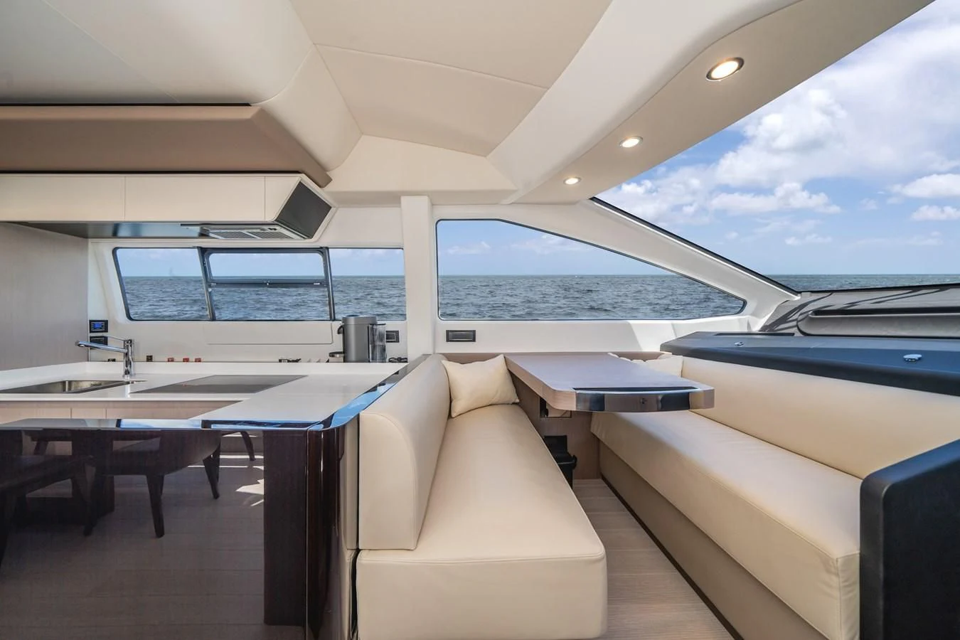 a room with a view of the ocean and the deck aboard 2022 AZIMUT 72 FLYBRIDGE OUR TRADE Yacht for Sale