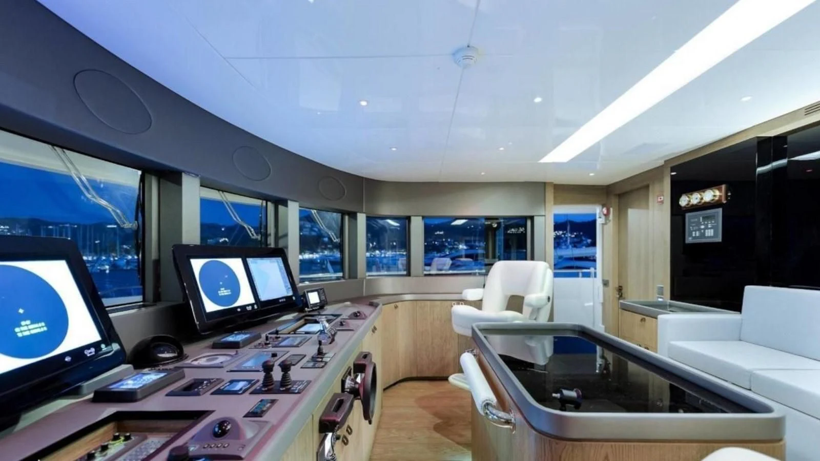 a room with a table and several screens aboard M 47 Yacht for Sale