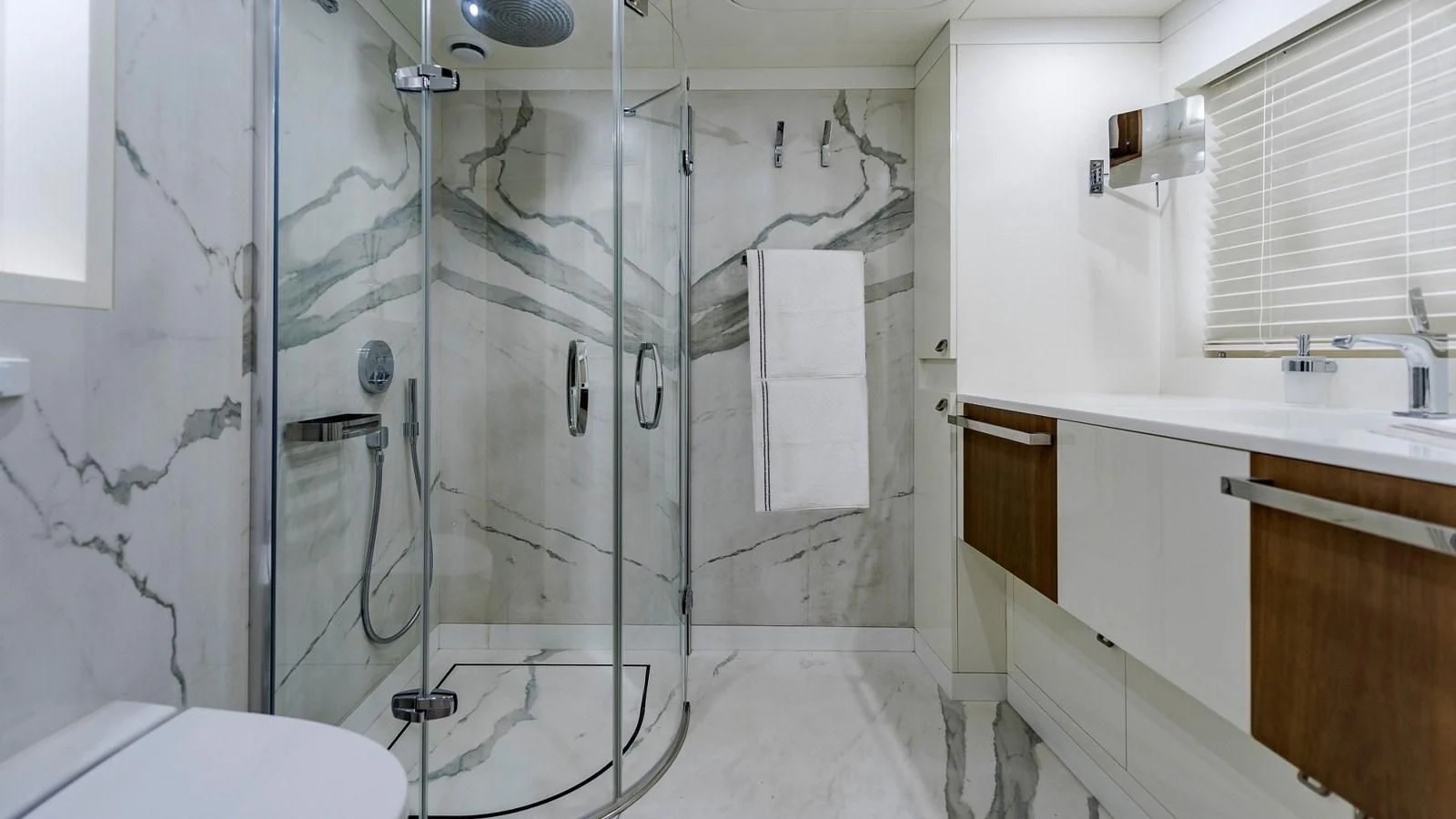 a bathroom with a glass shower aboard M 47 Yacht for Sale