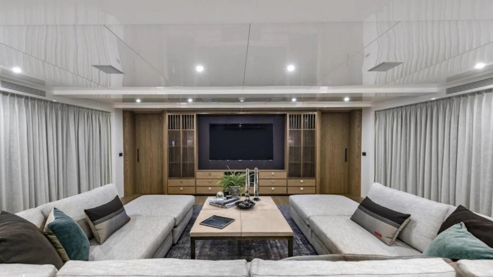 a living room with a tv and couches aboard M 47 Yacht for Sale