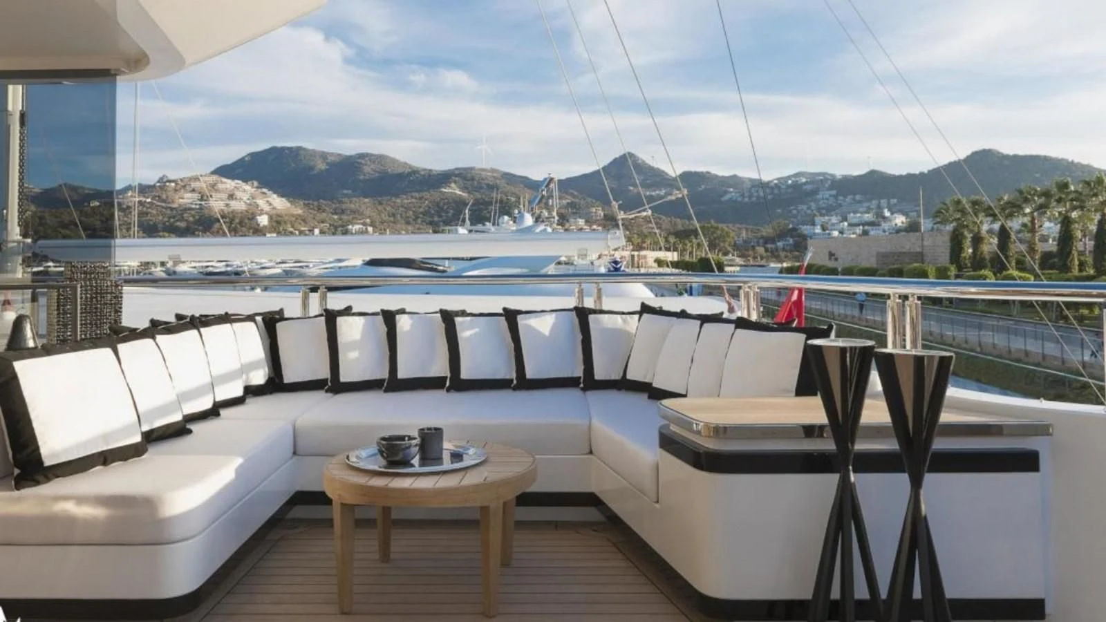 a room with a table and chairs on a deck overlooking a body of water aboard M 47 Yacht for Sale