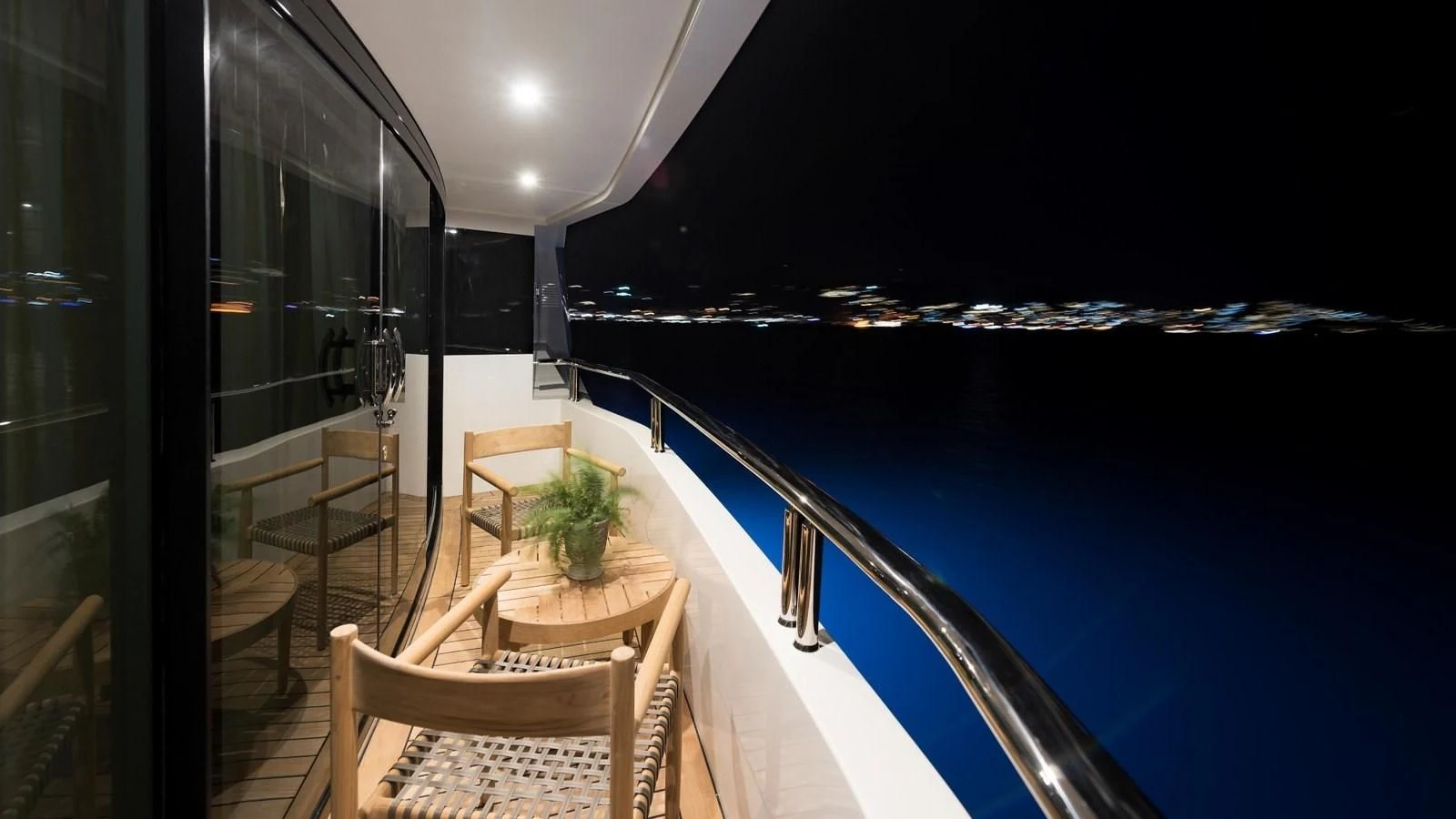 a balcony with a table and chairs aboard M 47 Yacht for Sale