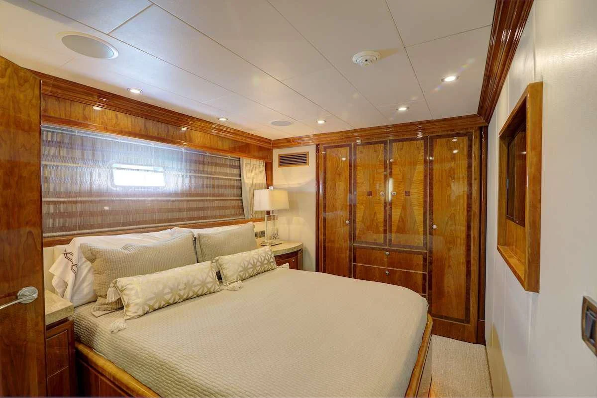 a bedroom with a bed and a wood door aboard STERLING V Yacht for Sale
