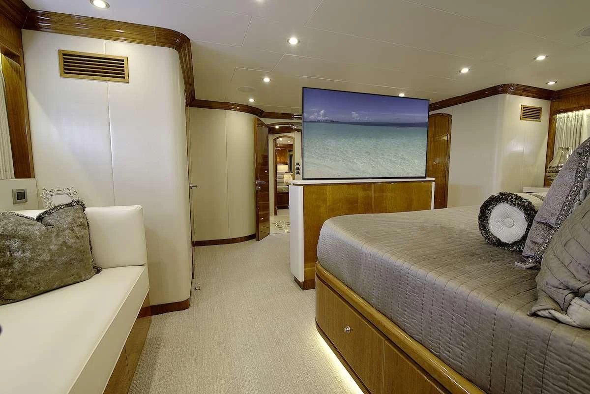 a bedroom with a bed and a couch aboard STERLING V Yacht for Sale