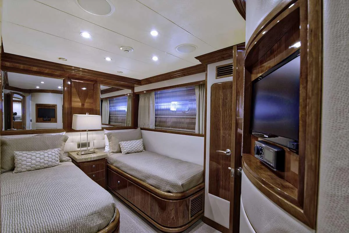 a hotel room with a bed and a television aboard STERLING V Yacht for Sale