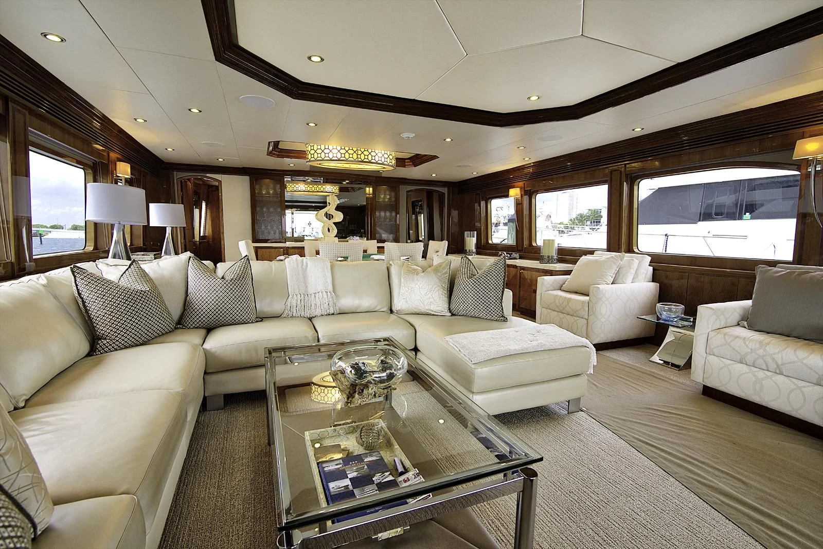 a living room with a large sofa and a coffee table aboard STERLING V Yacht for Sale