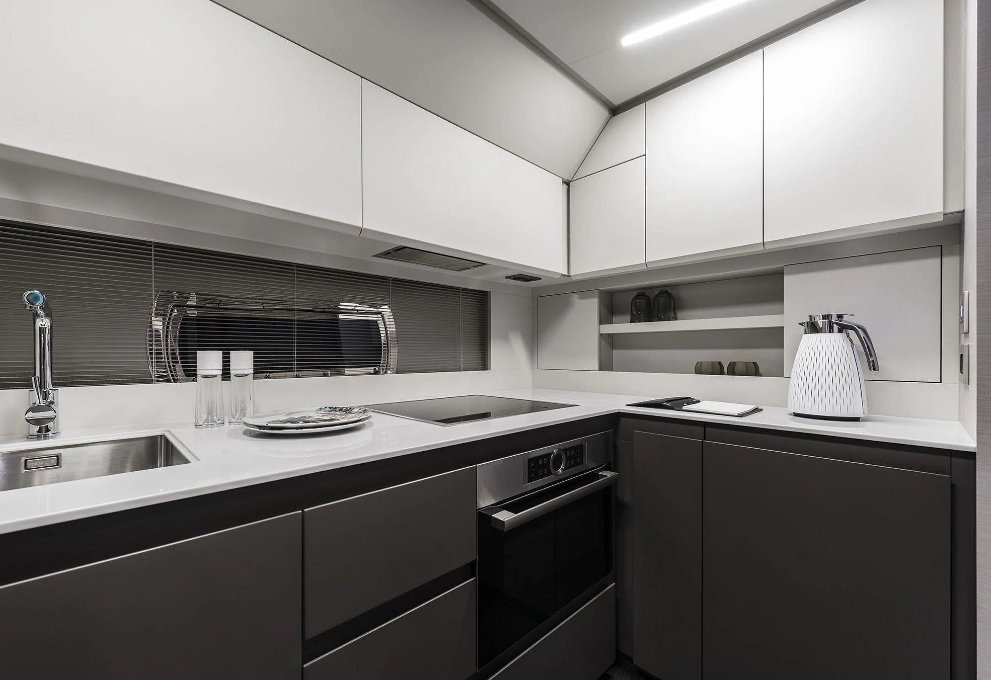 a kitchen with black appliances aboard UNREEL Yacht for Sale