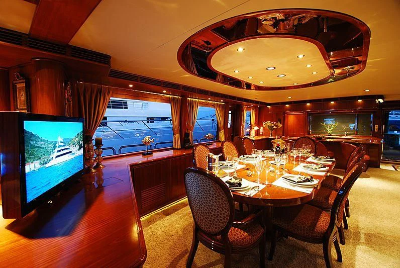 a large dining room with a large chandelier aboard FORTY LOVE Yacht for Charter