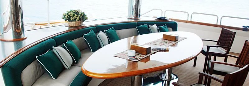 a table with a couch and a coffee table aboard FORTY LOVE Yacht for Charter