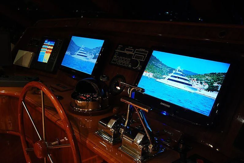 a cockpit with a screen and a game controller and a game controller aboard FORTY LOVE Yacht for Charter