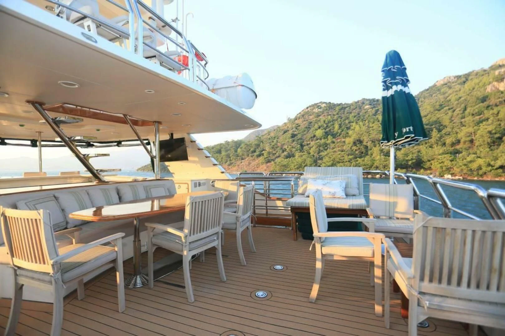a deck with tables and chairs on it aboard FORTY LOVE Yacht for Charter
