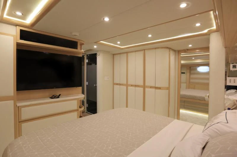 a room with a bed and a television aboard FORTY LOVE Yacht for Charter