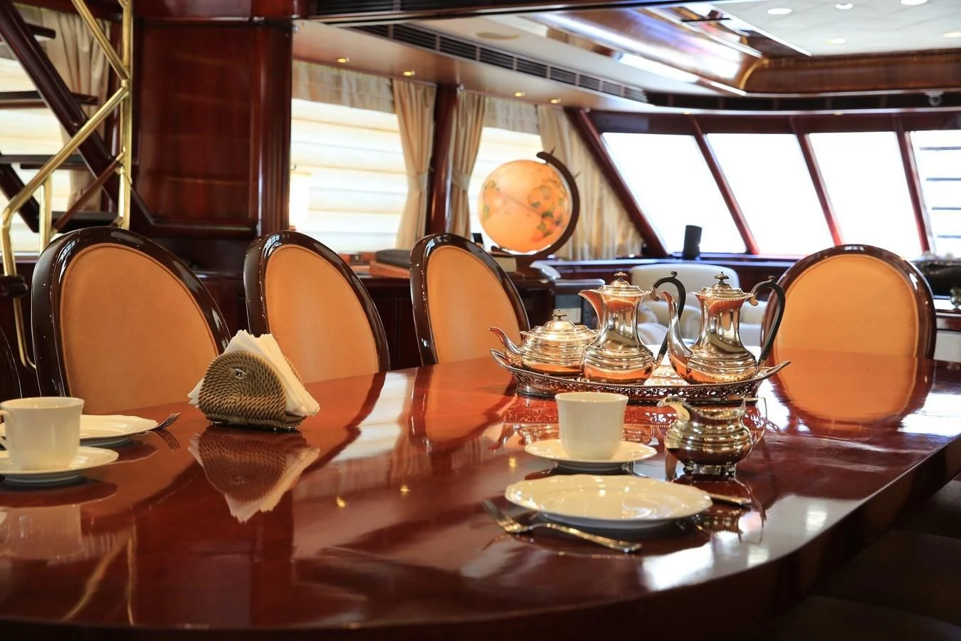 a table with a plate and cups on it aboard FORTY LOVE Yacht for Charter