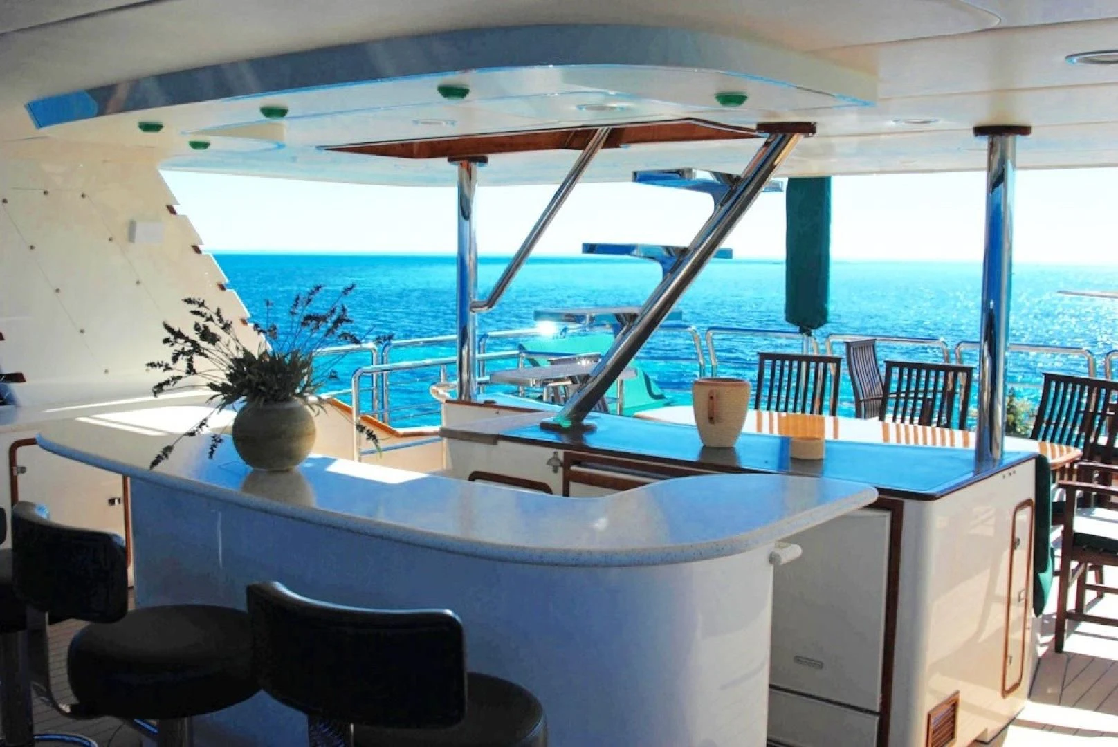 a large pool with a table and chairs aboard FORTY LOVE Yacht for Charter