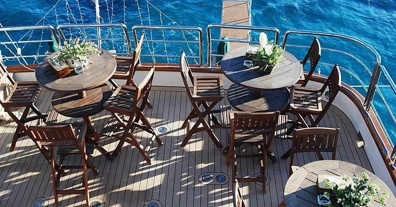 a deck with chairs and tables aboard FORTY LOVE Yacht for Charter