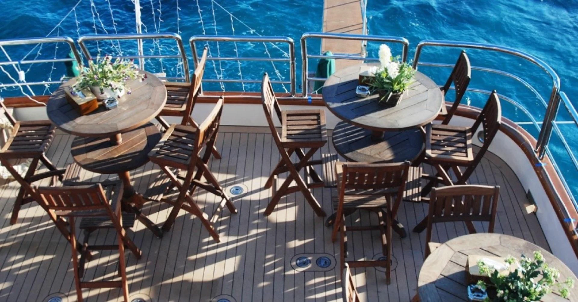 a table set with chairs and a pool aboard FORTY LOVE Yacht for Charter