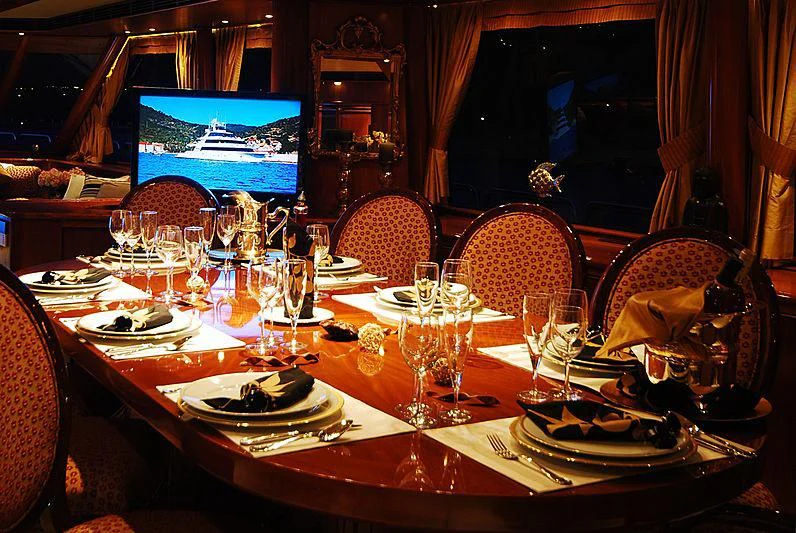 a table set with plates and glasses aboard FORTY LOVE Yacht for Charter