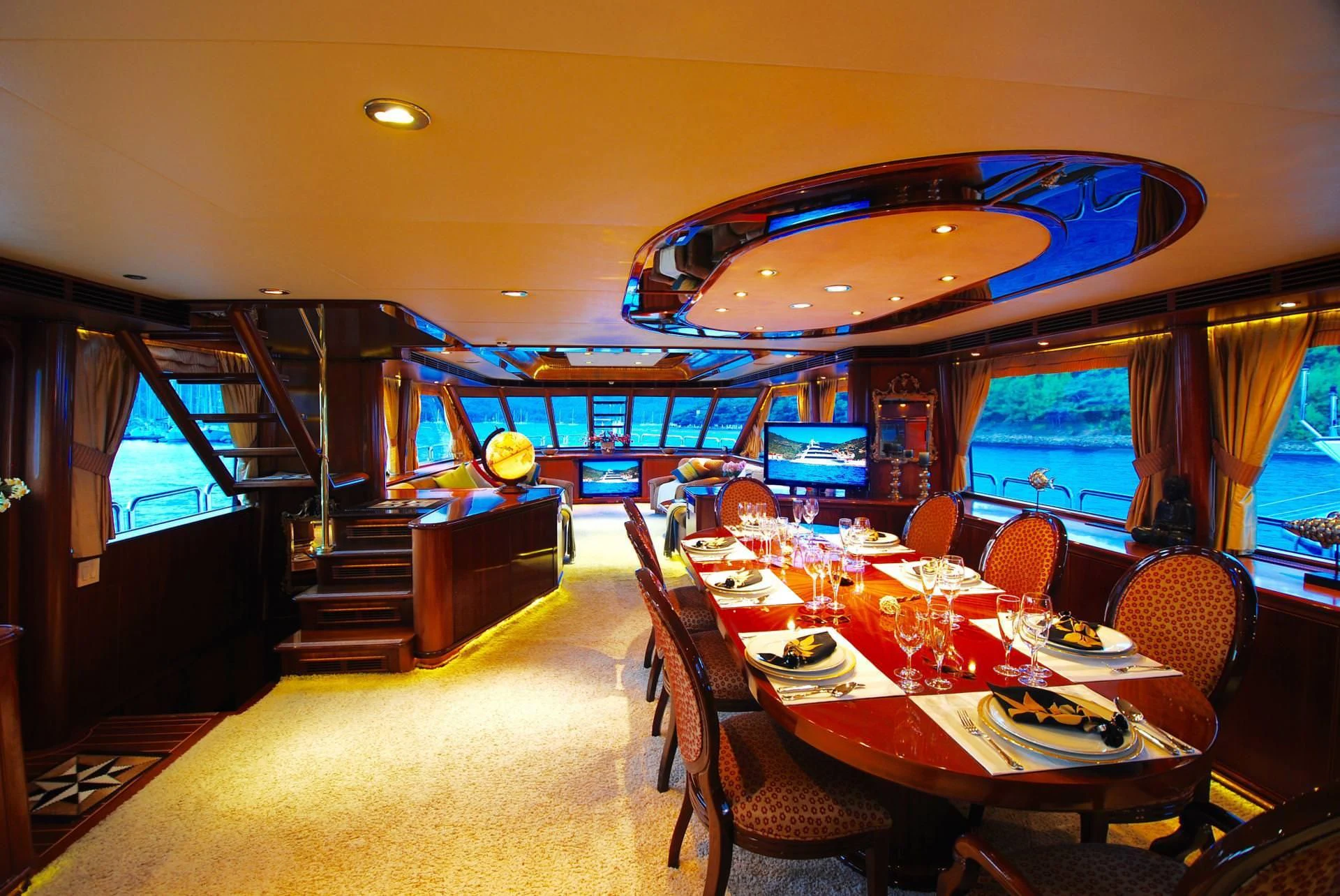 a dining room with a large chandelier aboard FORTY LOVE Yacht for Charter