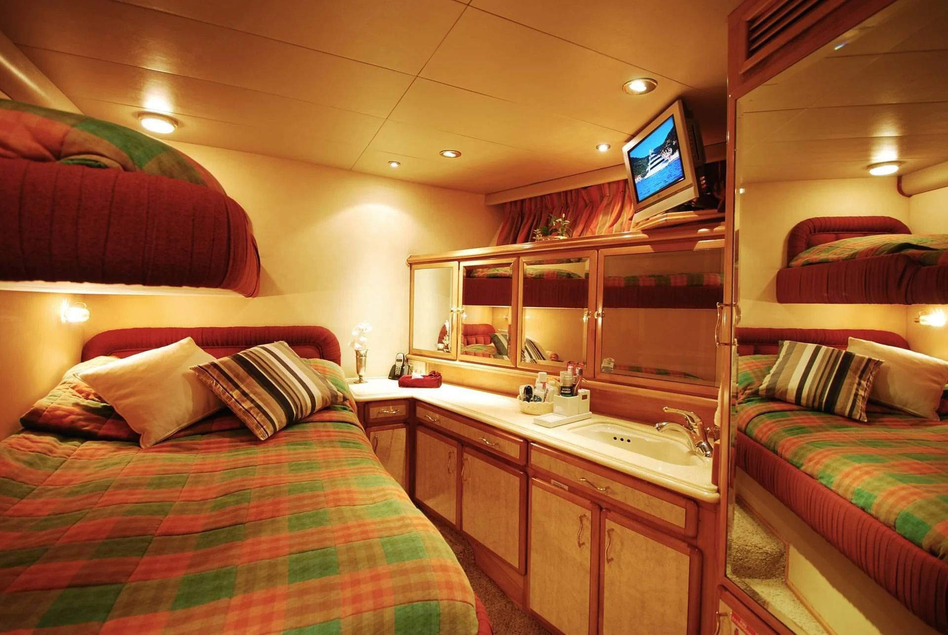 a room with a bed and a tv on the wall aboard FORTY LOVE Yacht for Charter