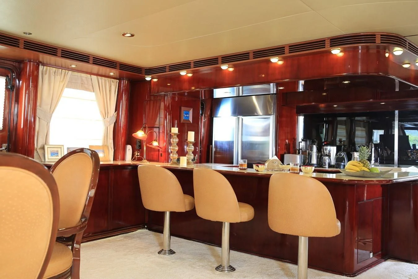 a large kitchen with a bar and chairs aboard FORTY LOVE Yacht for Charter