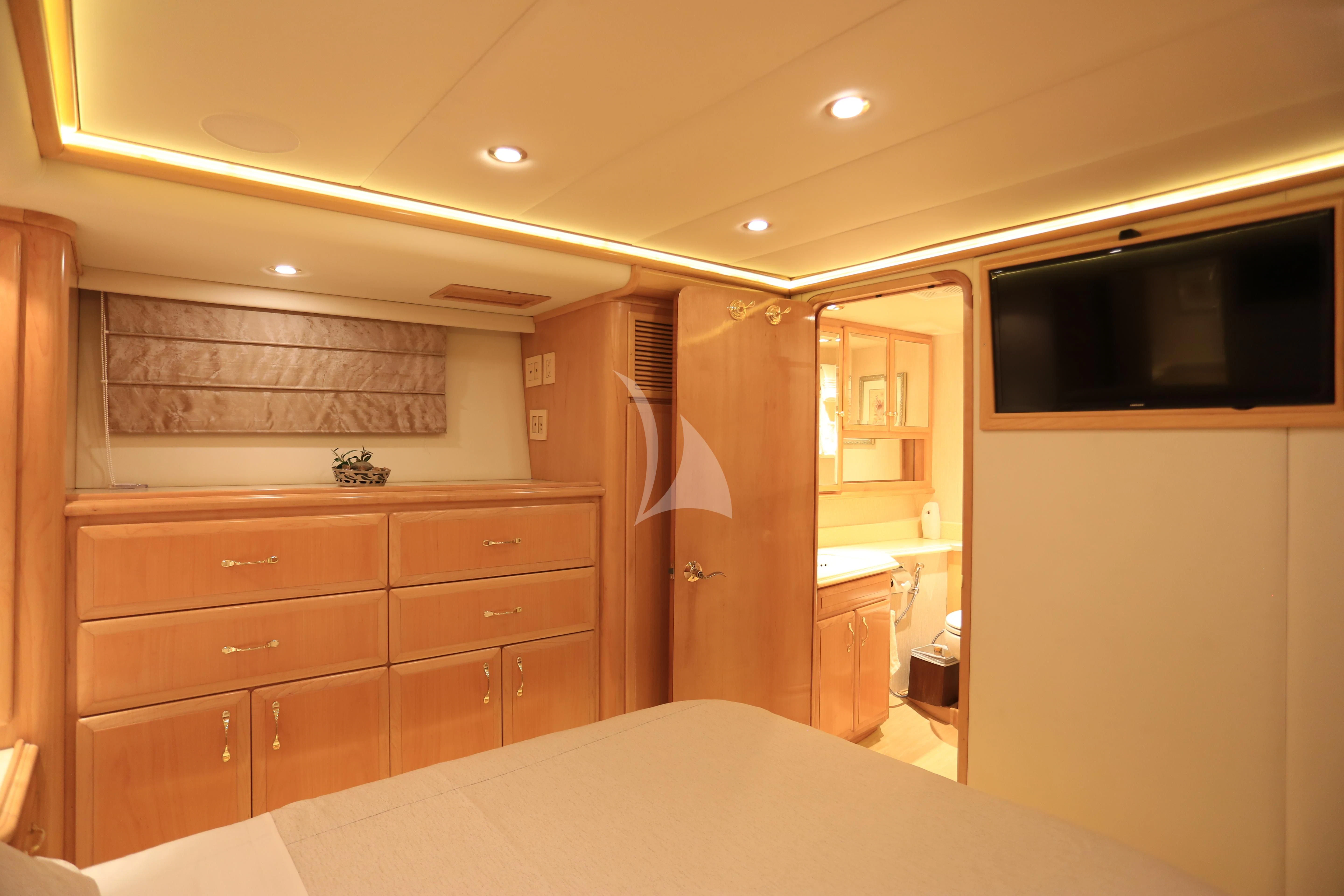 a bedroom with a bed and a television aboard FORTY LOVE Yacht for Charter
