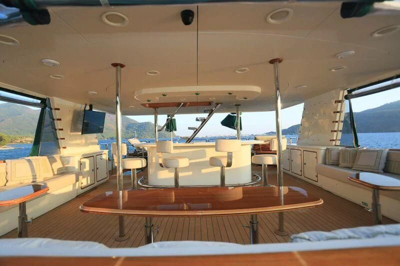 a room with tables and chairs aboard FORTY LOVE Yacht for Charter