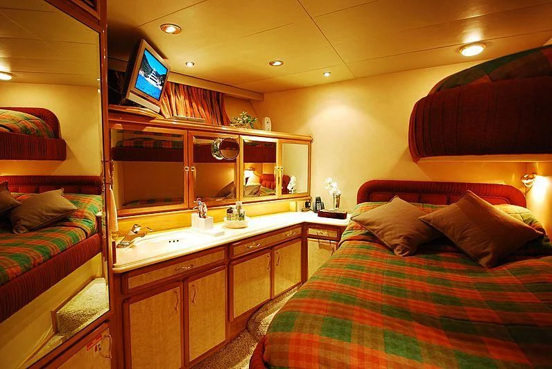 a bedroom with a bed and a tv on the wall aboard FORTY LOVE Yacht for Charter