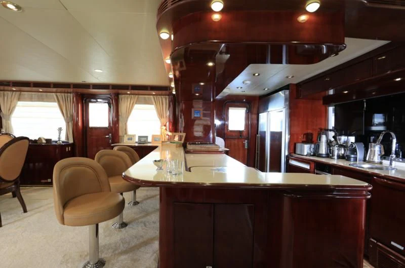 a kitchen with a bar and a table aboard FORTY LOVE Yacht for Charter