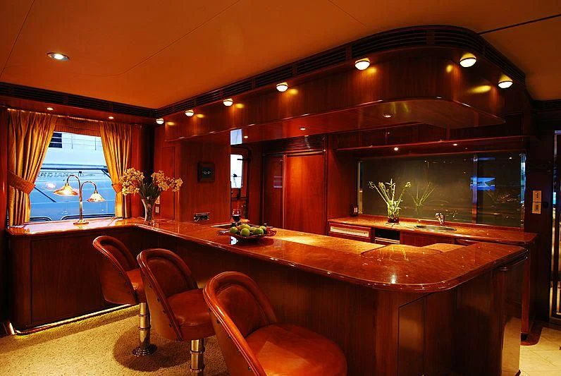 a large kitchen with a bar and chairs aboard FORTY LOVE Yacht for Charter