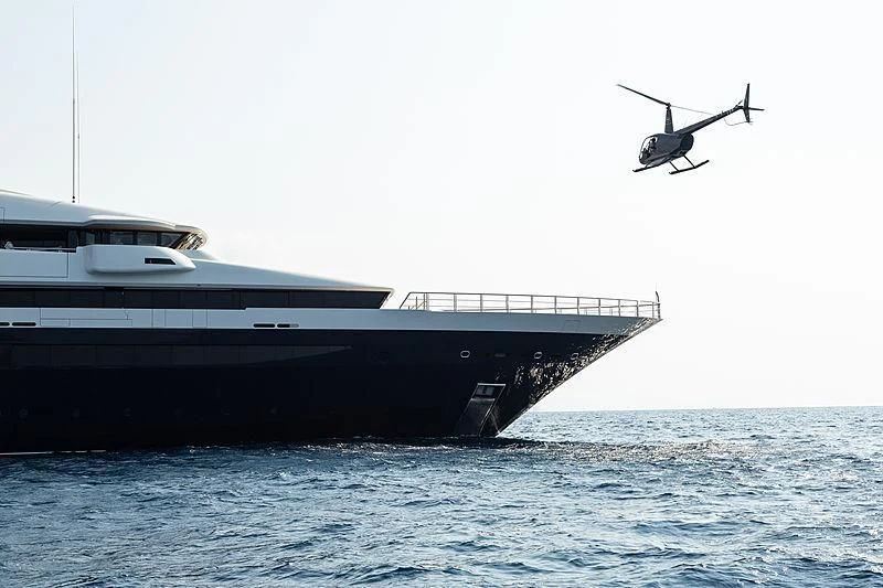 a helicopter flying over a boat aboard DRAAK Yacht for Sale