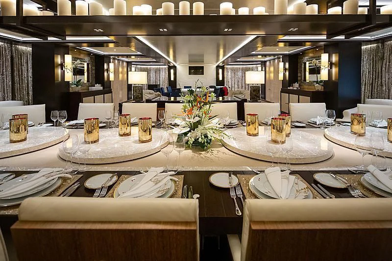 a table with plates and food on it aboard DRAAK Yacht for Sale