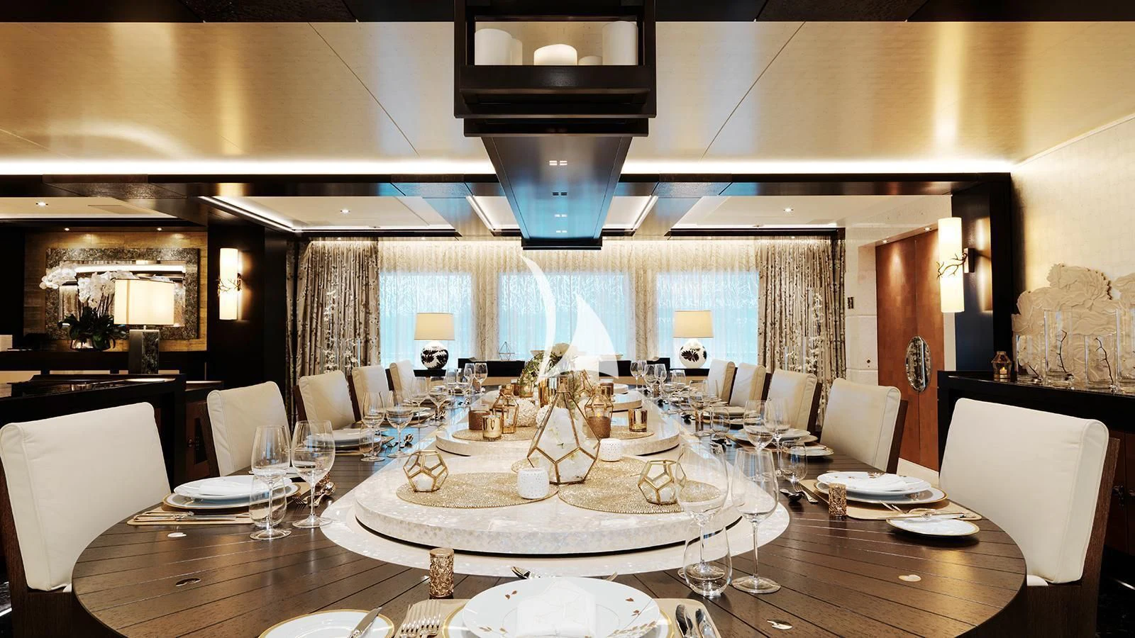a large room with tables and chairs aboard DRAAK Yacht for Sale