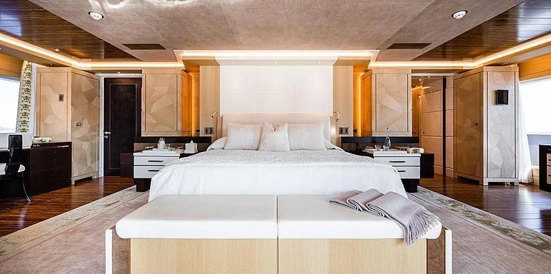 a large bedroom with a large bed aboard DRAAK Yacht for Sale