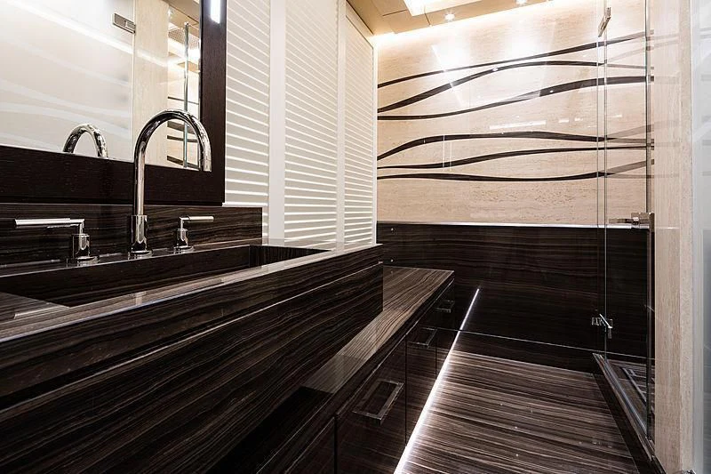 a bathroom with a tub and sinks aboard DRAAK Yacht for Sale