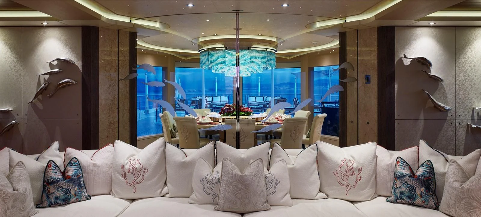 a room with a large sofa and a large window with a view of the city aboard DRAAK Yacht for Sale