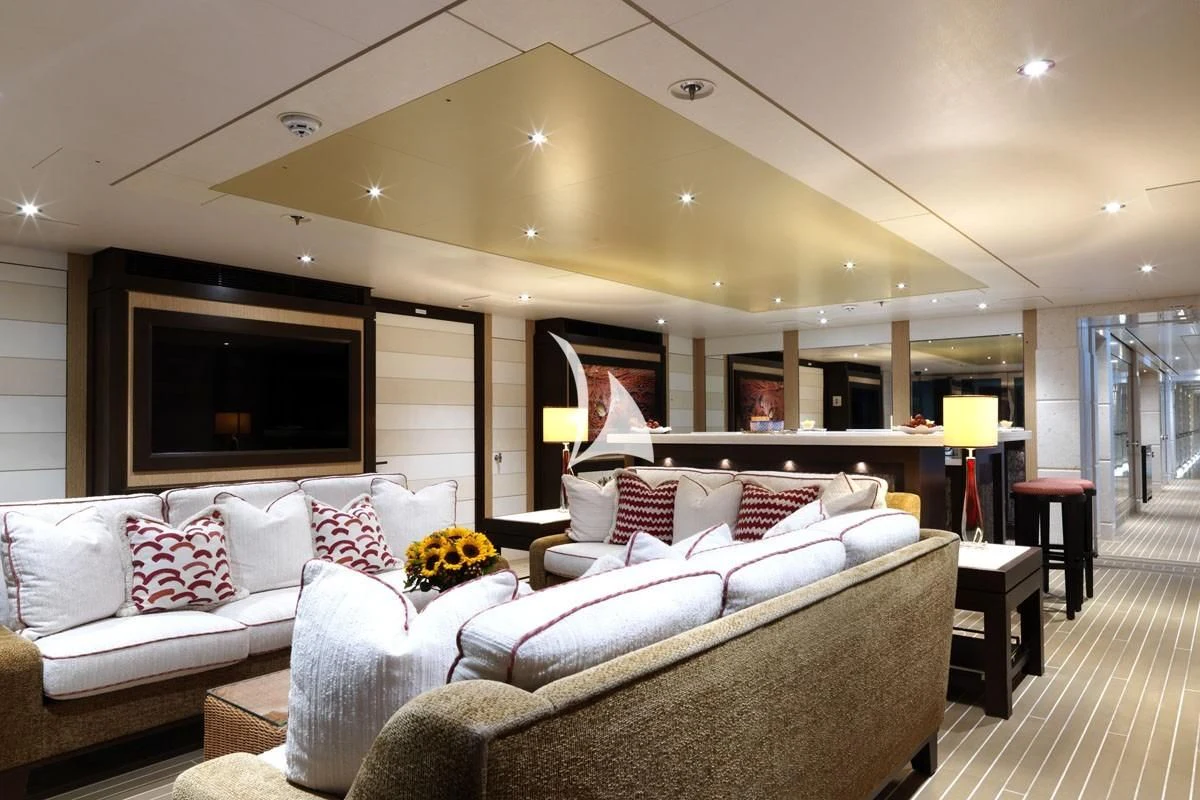 a living room with a large bed aboard DRAAK Yacht for Sale
