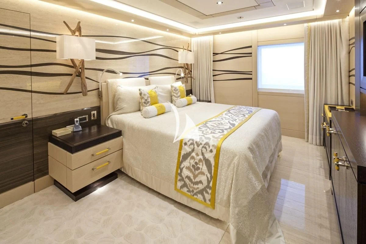 a bedroom with a bed and a desk aboard DRAAK Yacht for Sale