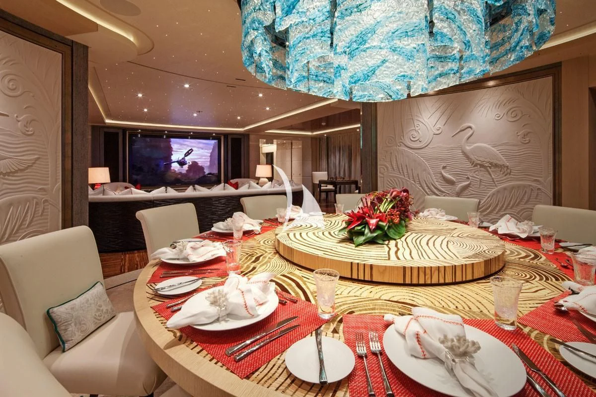 a table with plates and food on it aboard DRAAK Yacht for Sale