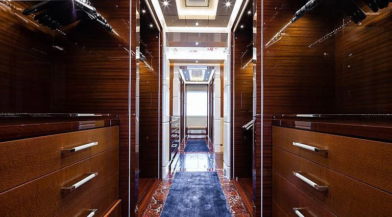 a hallway with wooden cabinets aboard DRAAK Yacht for Sale