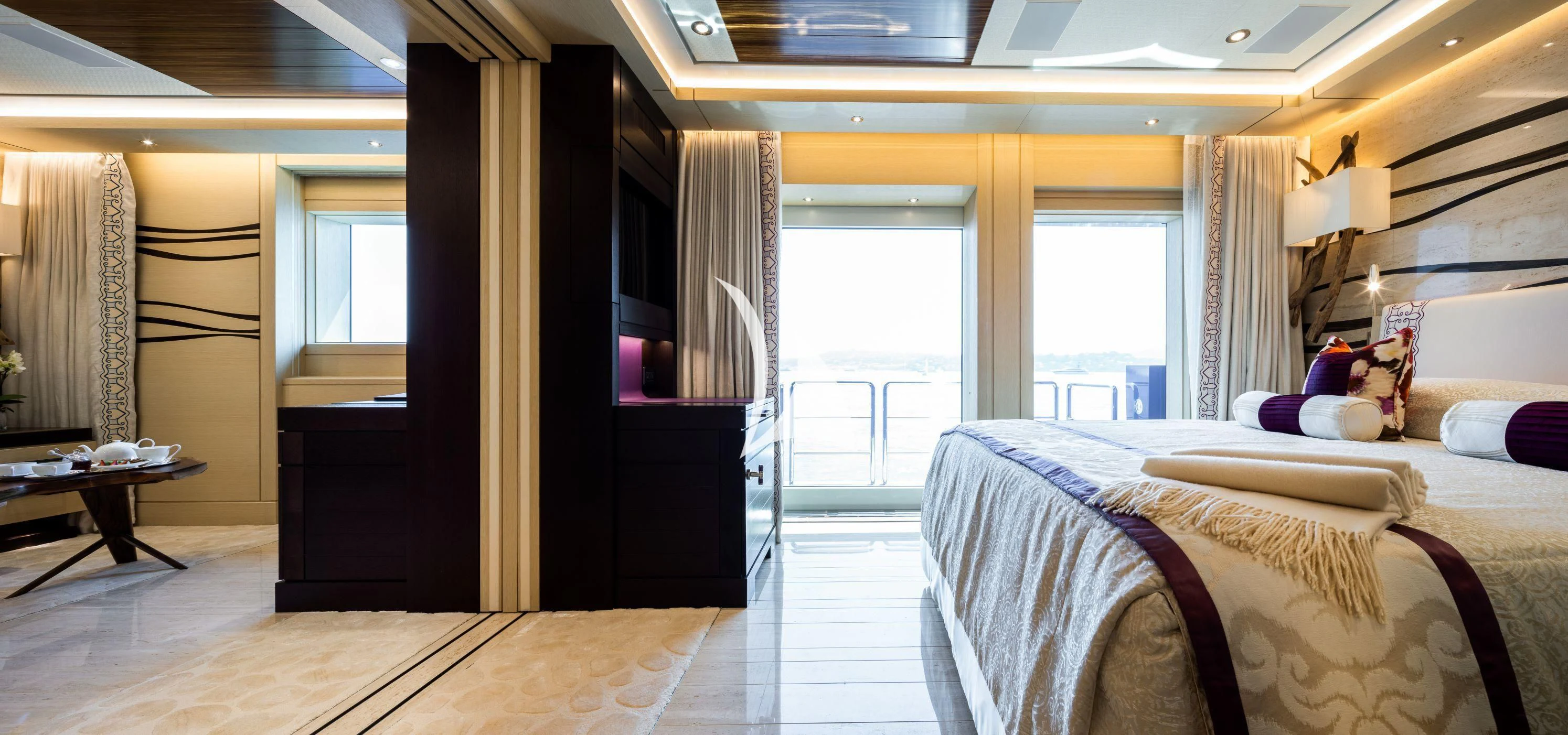 a bedroom with a bed and a desk aboard DRAAK Yacht for Sale