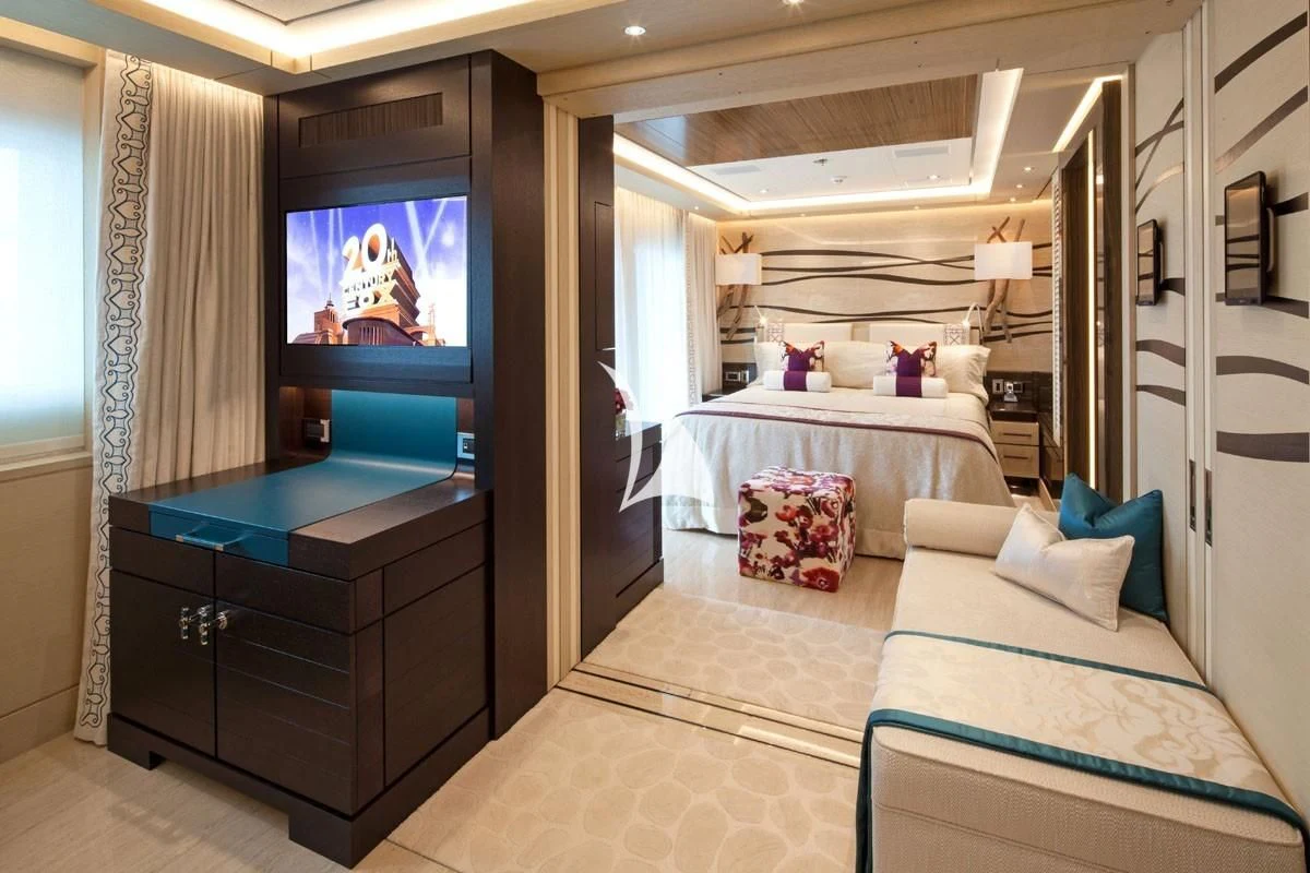 a bedroom with a bed and a television aboard DRAAK Yacht for Sale