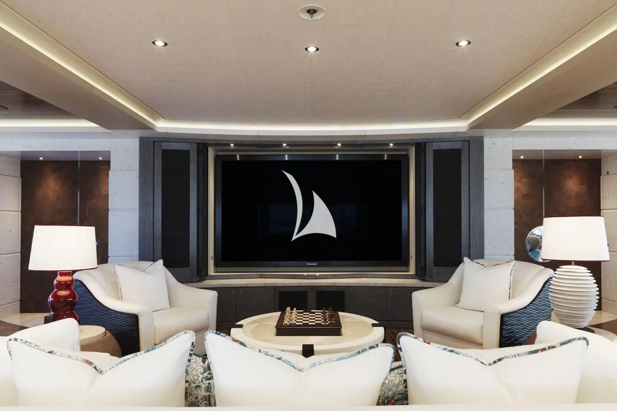 a living room with a large screen aboard DRAAK Yacht for Sale