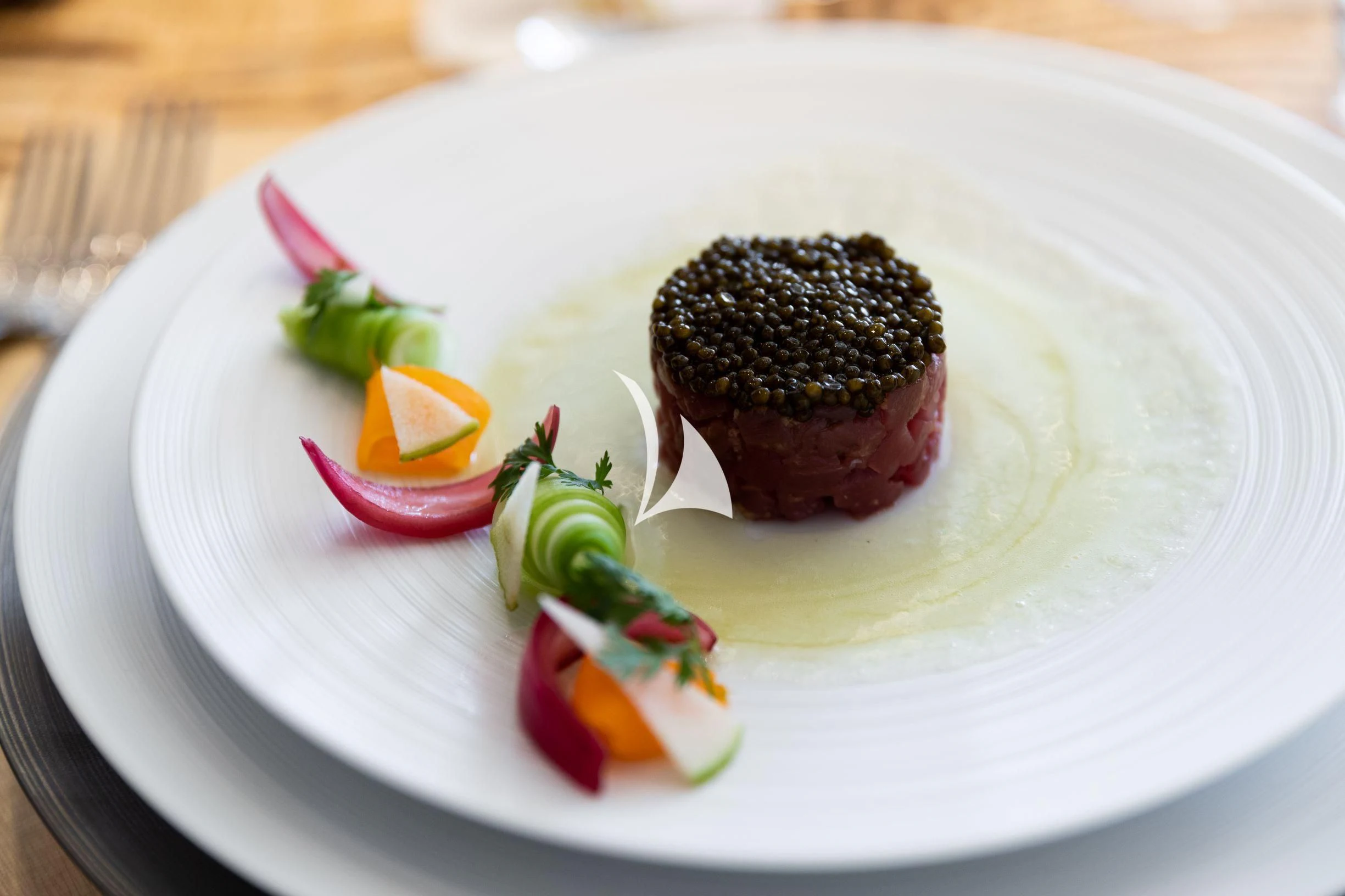 a plate of food aboard DRAAK Yacht for Sale