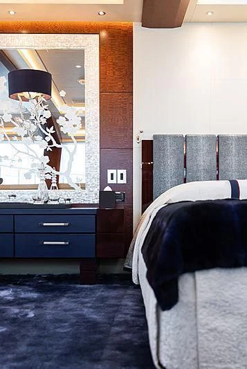 a bedroom with a bed and a mirror aboard DRAAK Yacht for Sale
